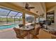 Outdoor dining set on the screened patio, perfect for enjoying meals with pool and water views at 1928 Cove Pointe Drive, Venice, FL 34293