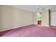 Bright bedroom features a view to the ensuite bathroom and neutral color walls at 1001 Old Mill Pond Rd, Palm Harbor, FL 34683