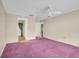 Large bedroom with neutral paint and ceiling fan; doorways lead to other rooms at 1001 Old Mill Pond Rd, Palm Harbor, FL 34683