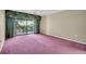 Spacious bedroom with sliding glass doors to balcony and plenty of natural light at 1001 Old Mill Pond Rd, Palm Harbor, FL 34683