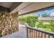 Deck with beautiful stone accent wall and lush landscaping at 1001 Old Mill Pond Rd, Palm Harbor, FL 34683