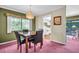 Dining room features a chandelier and a view of the backyard patio through the large windows at 1001 Old Mill Pond Rd, Palm Harbor, FL 34683