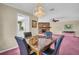 Elegant dining room with stylish chandelier, marble table, and views of the living room and kitchen at 1001 Old Mill Pond Rd, Palm Harbor, FL 34683