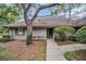 Inviting front entrance with a concrete walkway and lush landscaping around the property at 1001 Old Mill Pond Rd, Palm Harbor, FL 34683