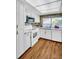 Well-lit kitchen with modern appliances, white cabinets, and lots of natural light at 1001 Old Mill Pond Rd, Palm Harbor, FL 34683