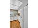 Bright kitchen featuring white cabinetry, modern appliances, and a lovely view from the window at 1001 Old Mill Pond Rd, Palm Harbor, FL 34683