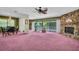 Spacious living room features a stone fireplace, large windows and unique vintage design at 1001 Old Mill Pond Rd, Palm Harbor, FL 34683