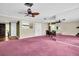 Open concept living room with decorative chandelier, ceiling fan and plenty of natural light at 1001 Old Mill Pond Rd, Palm Harbor, FL 34683