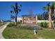 Welcome to Sherman Oaks! Beautiful community entrance with lush landscaping and clear signage at 30866 Wild Juniper Ct, Brooksville, FL 34602