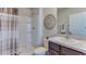 Bathroom with a shower, patterned shower curtain, a vanity, and modern fixtures at 30872 Wild Juniper Ct, Brooksville, FL 34602
