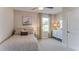 Neutral bedroom with a cozy bed, side table, decorative dresser, and patterned curtains at 30872 Wild Juniper Ct, Brooksville, FL 34602
