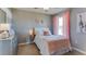 Bedroom with a bed, pink accents, a metallic dresser, and a decorative giraffe artwork at 30872 Wild Juniper Ct, Brooksville, FL 34602