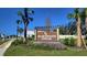 Sherman Oaks community sign with lush landscaping and clear blue skies in the background at 30872 Wild Juniper Ct, Brooksville, FL 34602