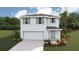 Charming two-story home featuring a two-car garage, neutral exterior, and well-maintained landscaping at 30872 Wild Juniper Ct, Brooksville, FL 34602