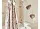 Bathroom features a shower with floral curtains at 12494 Moon Rd, Brooksville, FL 34613
