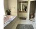 Bathroom features a tub, tiled floors, and a large vanity area at 9685 Southern Belle Dr, Weeki Wachee, FL 34613