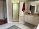 Bathroom featuring a glass shower, large mirror, vanity and tile floors at 9685 Southern Belle Dr, Weeki Wachee, FL 34613