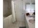 Bathroom featuring walk-in bathtub, vanity, and neutral tile at 9685 Southern Belle Dr, Weeki Wachee, FL 34613