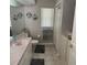 Bathroom featuring large mirror, vanity, toilet, and shower with textured tile at 9685 Southern Belle Dr, Weeki Wachee, FL 34613