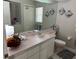 Bathroom featuring a vanity, decorative mirror, toilet, and shower at 9685 Southern Belle Dr, Weeki Wachee, FL 34613