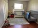 Cozy bedroom with two cribs, natural light and fun toys at 9685 Southern Belle Dr, Weeki Wachee, FL 34613