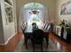 Elegant dining room boasts a large window with sheer curtains and a stylish chandelier above the table at 9685 Southern Belle Dr, Weeki Wachee, FL 34613