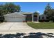 Charming single-story home with a two-car garage, well-manicured lawn, and inviting curb appeal at 9685 Southern Belle Dr, Weeki Wachee, FL 34613