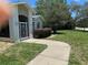Front view of a single Gathering home featuring mature landscaping and a decorative white metal security door at 9685 Southern Belle Dr, Weeki Wachee, FL 34613