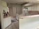 Eat-in kitchen features tile floors, island with cooktop, white cabinets, and matching appliances at 9685 Southern Belle Dr, Weeki Wachee, FL 34613