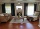 Cozy living room featuring hardwood floors, a fireplace, comfortable seating, and stylish decor at 9685 Southern Belle Dr, Weeki Wachee, FL 34613