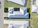 Aerial view of a home showcasing a modern metal roof and an enclosed pool at 10391 Coquina Ct, Placida, FL 33946