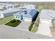 An aerial view of the home highlights its landscaping, driveway, and color scheme at 10391 Coquina Ct, Placida, FL 33946