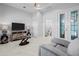 Bright bedroom featuring marble floors, a TV, and an ensuite bathroom at 10391 Coquina Ct, Placida, FL 33946