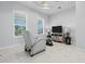 Cozy bedroom with a recliner, marble floors, and plenty of natural light at 10391 Coquina Ct, Placida, FL 33946