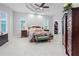 Spacious main bedroom with tray ceiling, plantation shutters, and walk-in closet at 10391 Coquina Ct, Placida, FL 33946