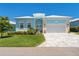 Charming single-Gathering home with lush landscaping, beautiful front door, and paved driveway at 10391 Coquina Ct, Placida, FL 33946