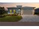Charming single-Gathering home with a well-manicured lawn and a two-car garage at sunset at 10391 Coquina Ct, Placida, FL 33946