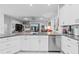 Open concept kitchen with granite countertops, stainless steel appliances, and view to the living area at 10391 Coquina Ct, Placida, FL 33946
