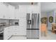 Bright kitchen featuring white cabinets, granite countertops, and stainless steel appliances at 10391 Coquina Ct, Placida, FL 33946