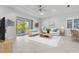 Bright living room with modern furniture and access to a screened-in lanai at 10391 Coquina Ct, Placida, FL 33946