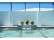 Close-up of a pool with fountains and potted plants creating a serene backyard oasis at 10391 Coquina Ct, Placida, FL 33946