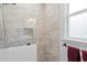 The shower features tile walls and a modern handheld showerhead at 10391 Coquina Ct, Placida, FL 33946