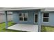 Covered back porch with access to the backyard at 13243 Gulf Bay Ln, Spring Hill, FL 34609