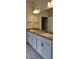 Bathroom featuring double sinks, granite countertops, and contemporary fixtures and hardware at 13243 Gulf Bay Ln, Spring Hill, FL 34609