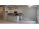 Open kitchen with white cabinets, granite countertops, an island, and stainless steel appliances at 13243 Gulf Bay Ln, Spring Hill, FL 34609