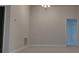 Minimalist living room with neutral walls, carpet flooring, and modern lighting fixtures at 13243 Gulf Bay Ln, Spring Hill, FL 34609