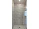 Luxurious bathroom with glass shower, rain shower head, and horizontal tile at 13243 Gulf Bay Ln, Spring Hill, FL 34609