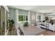Bright dining area with large windows, modern table and chairs, and an open-concept layout leading to the living room at 30860 Wild Juniper Ct, Brooksville, FL 34602