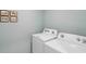 Efficient laundry room with modern appliances and playful decor, perfect for keeping things organized and tidy at 30860 Wild Juniper Ct, Brooksville, FL 34602