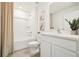 Bathroom with tiled floors, white vanity, shower and tub combo, and large mirror at 6052 Shiprock Ave, Spring Hill, FL 34608